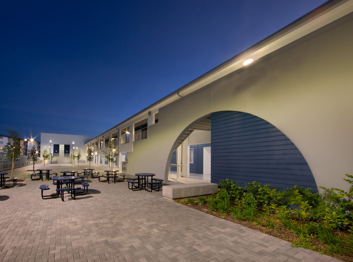 Architectural dusk view of the courtyard at Pinecrest prep charter k-12 school in Miami.